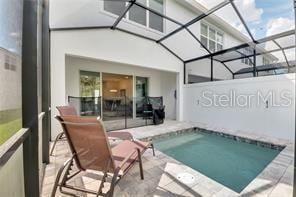 view of pool featuring a lanai and a patio area