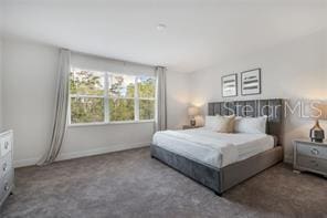 bedroom featuring carpet and baseboards