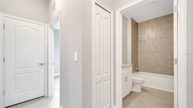 full bath with shower / bathtub combination, visible vents, toilet, vanity, and tile patterned floors