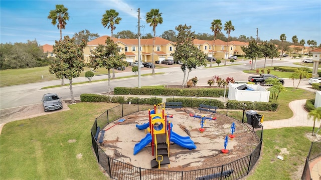 exterior space featuring a residential view, fence, and playground community