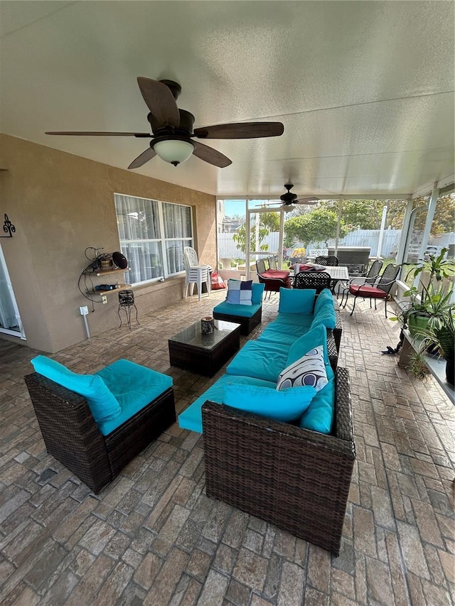 view of patio with fence, an outdoor living space, and a ceiling fan