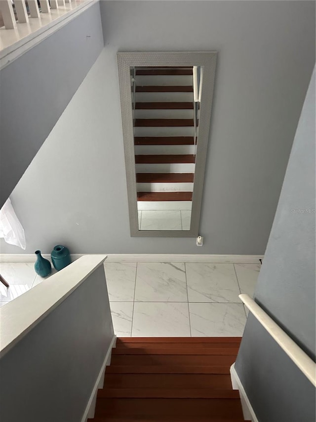 stairs featuring marble finish floor