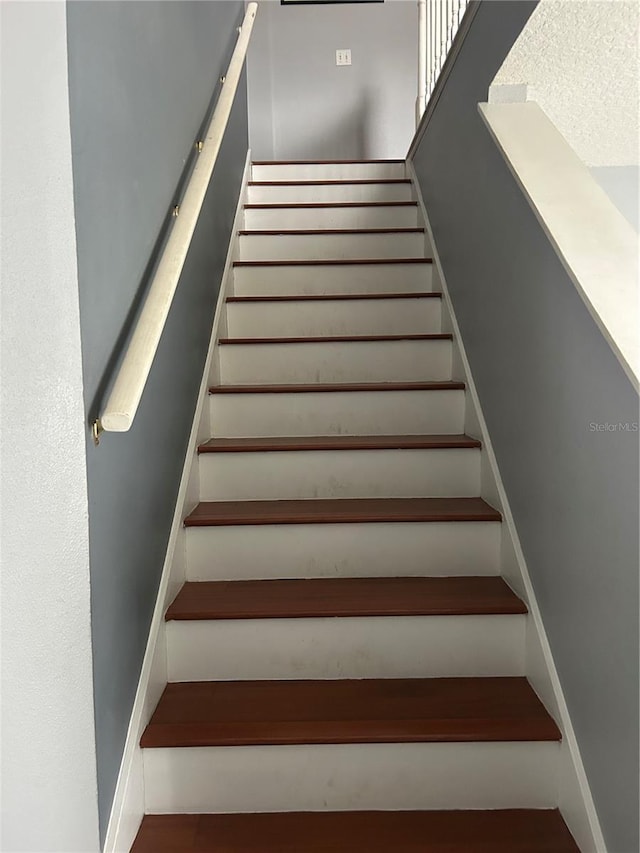 staircase featuring baseboards