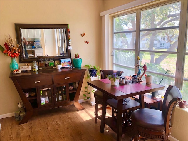 dining space with baseboards and light wood-style floors