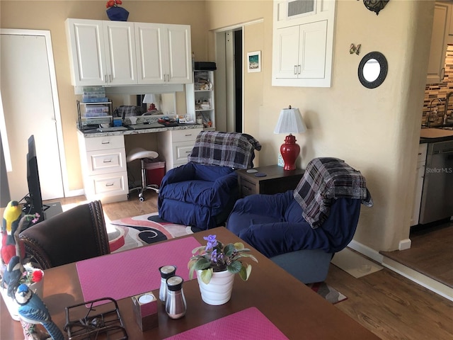 living area with light wood-type flooring and built in desk