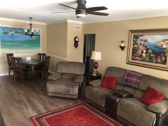 living room featuring crown molding, visible vents, wood finished floors, baseboards, and ceiling fan with notable chandelier