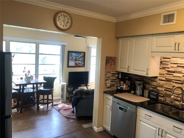 kitchen with visible vents, white cabinets, dishwasher, dark wood-style floors, and a sink