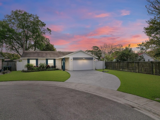 ranch-style house with an attached garage, fence, a lawn, and concrete driveway