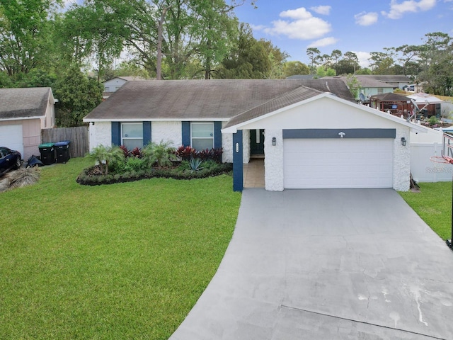 ranch-style house featuring an attached garage, concrete driveway, a front yard, and fence