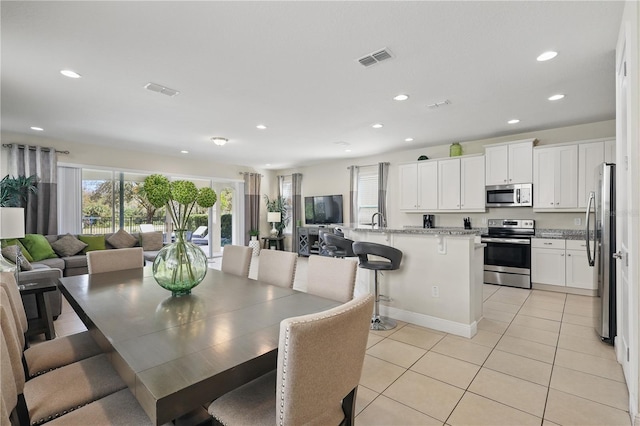 dining space featuring recessed lighting, visible vents, and light tile patterned flooring