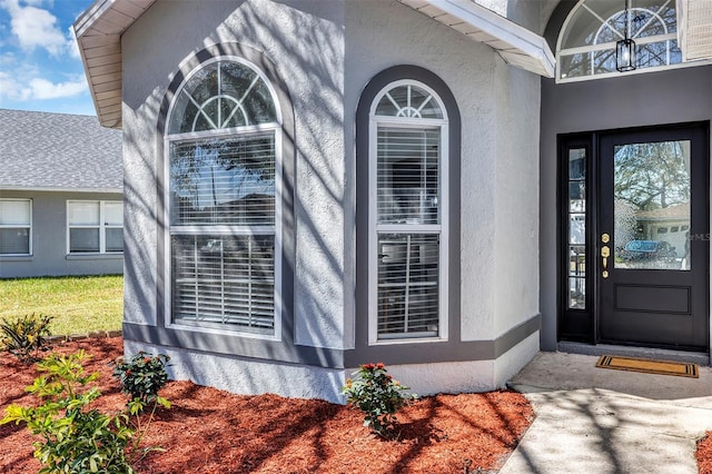 property entrance featuring stucco siding