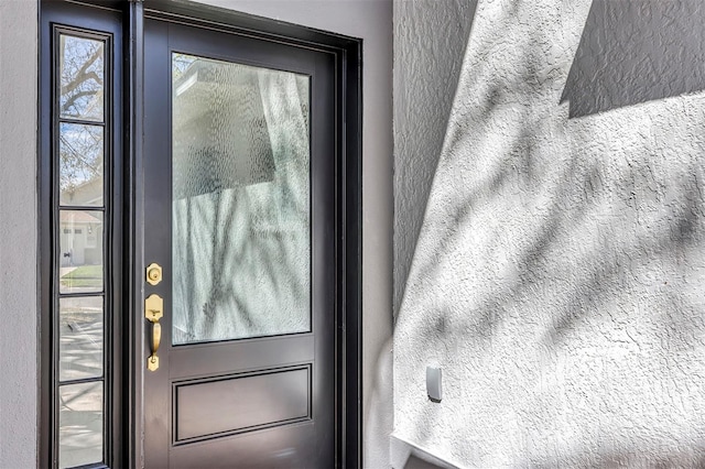 doorway to outside with a textured wall