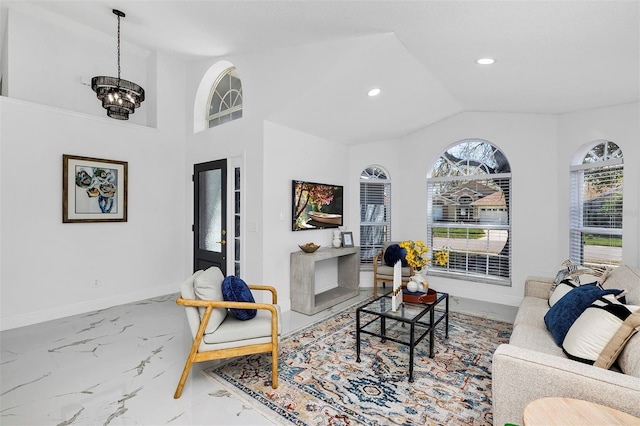 living area featuring baseboards, lofted ceiling, marble finish floor, a notable chandelier, and recessed lighting