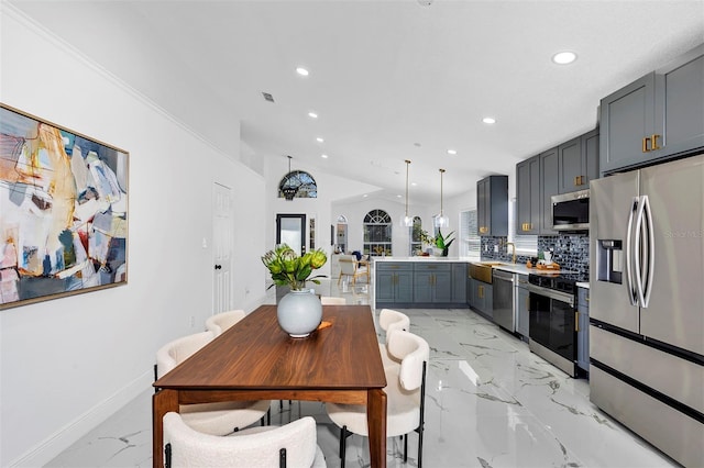 kitchen featuring stainless steel appliances, recessed lighting, marble finish floor, and a peninsula