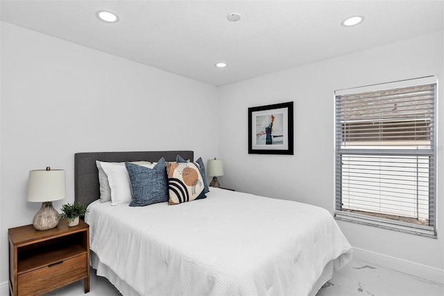 bedroom featuring baseboards, marble finish floor, a textured ceiling, and recessed lighting