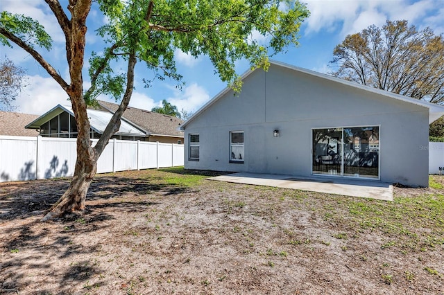 back of property with a patio and fence