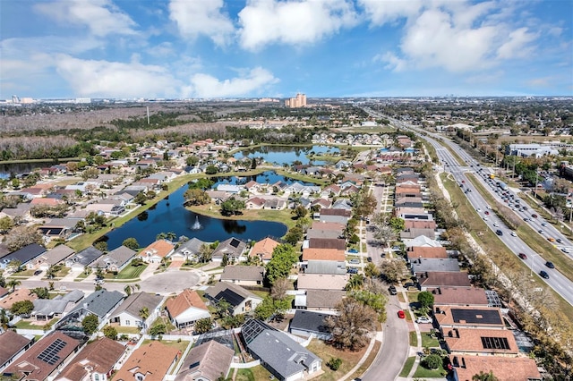 birds eye view of property featuring a water view and a residential view