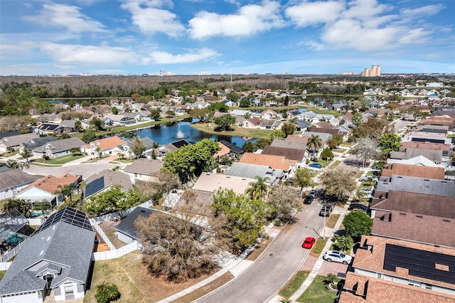 birds eye view of property with a water view and a residential view