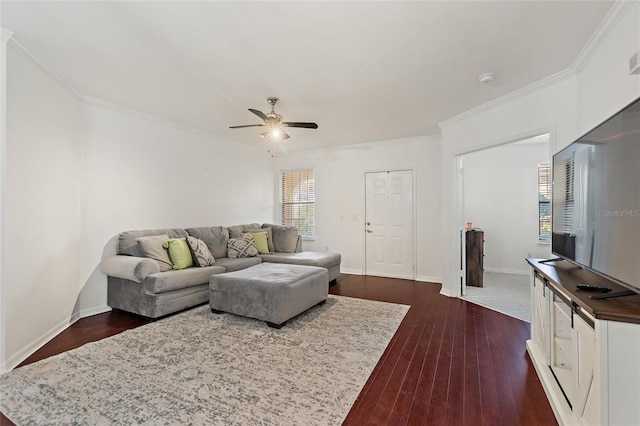 living area featuring ornamental molding, dark wood finished floors, and baseboards