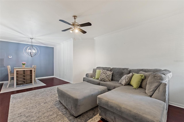 living room featuring dark wood-style floors, ceiling fan with notable chandelier, baseboards, and crown molding