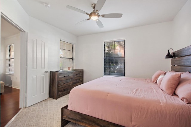 bedroom with ceiling fan and baseboards