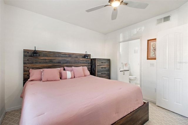 bedroom with baseboards, visible vents, ceiling fan, and ensuite bathroom