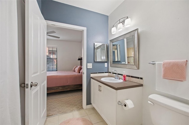 full bathroom featuring toilet, ceiling fan, vanity, ensuite bath, and tile patterned flooring