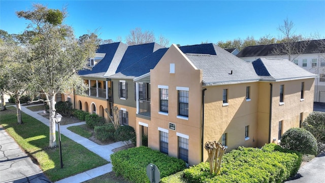 view of home's exterior featuring a lawn and stucco siding