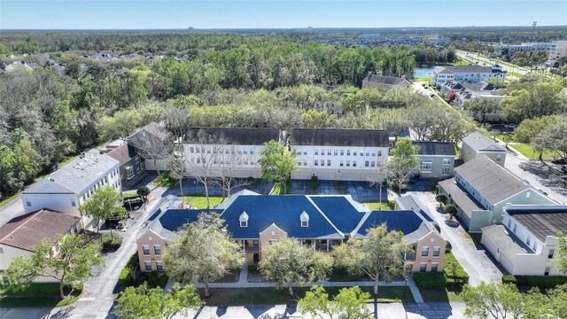 drone / aerial view with a wooded view