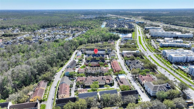 birds eye view of property featuring a forest view