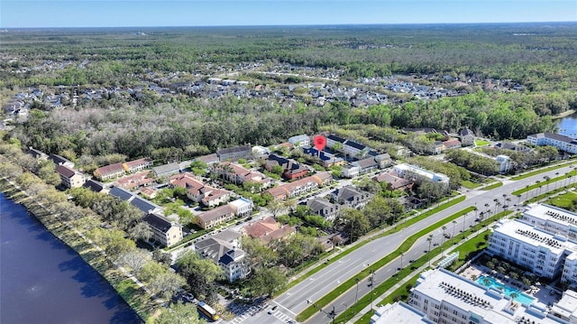 birds eye view of property featuring a water view and a view of trees