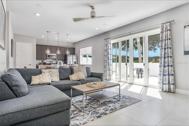 tiled living area featuring recessed lighting, a ceiling fan, and baseboards