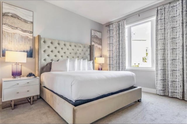 bedroom featuring baseboards and carpet floors