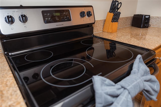 interior details with electric range and light countertops