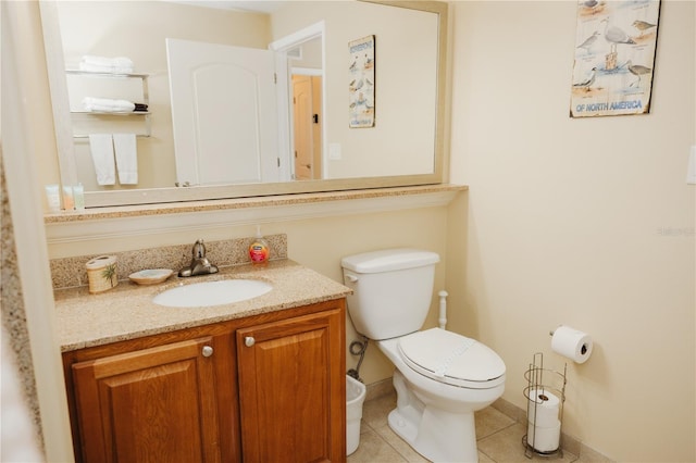 half bathroom featuring tile patterned floors, toilet, vanity, and baseboards