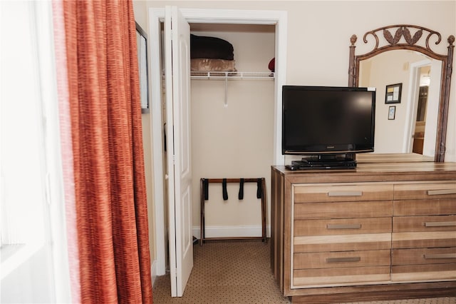 bedroom featuring a closet and baseboards