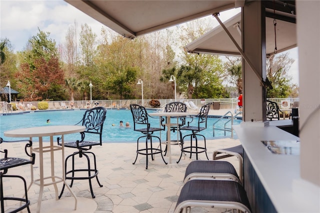 pool featuring a patio area and fence