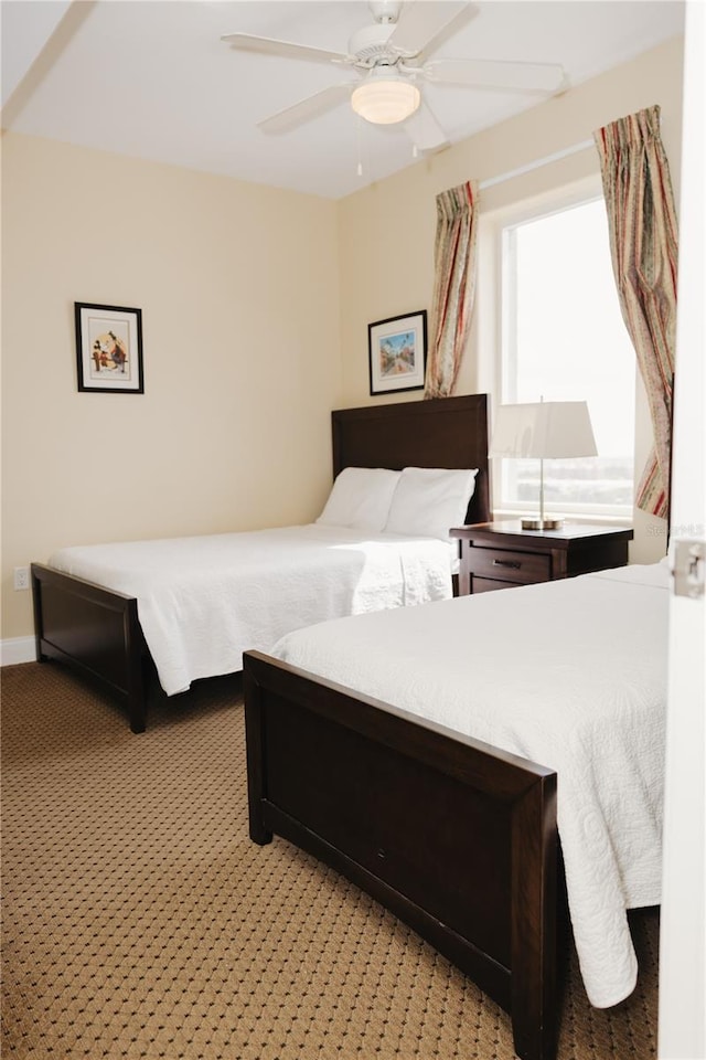 bedroom featuring a ceiling fan and light colored carpet