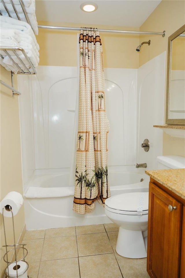 bathroom featuring tile patterned floors, shower / bath combo with shower curtain, toilet, and vanity