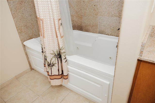 bathroom with tile patterned flooring and a jetted tub