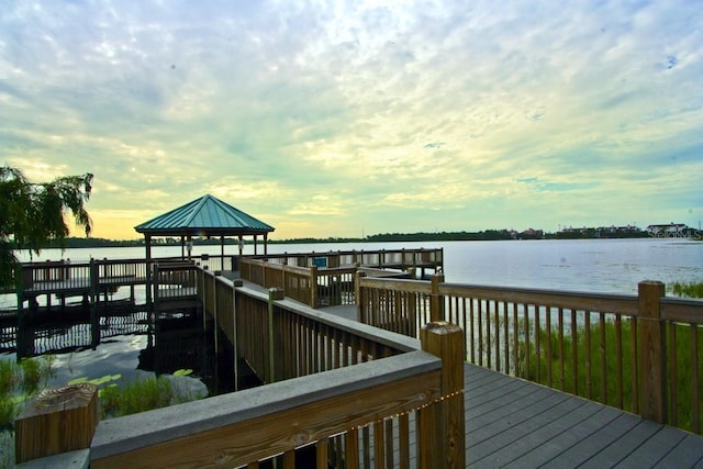 dock area with a gazebo and a water view