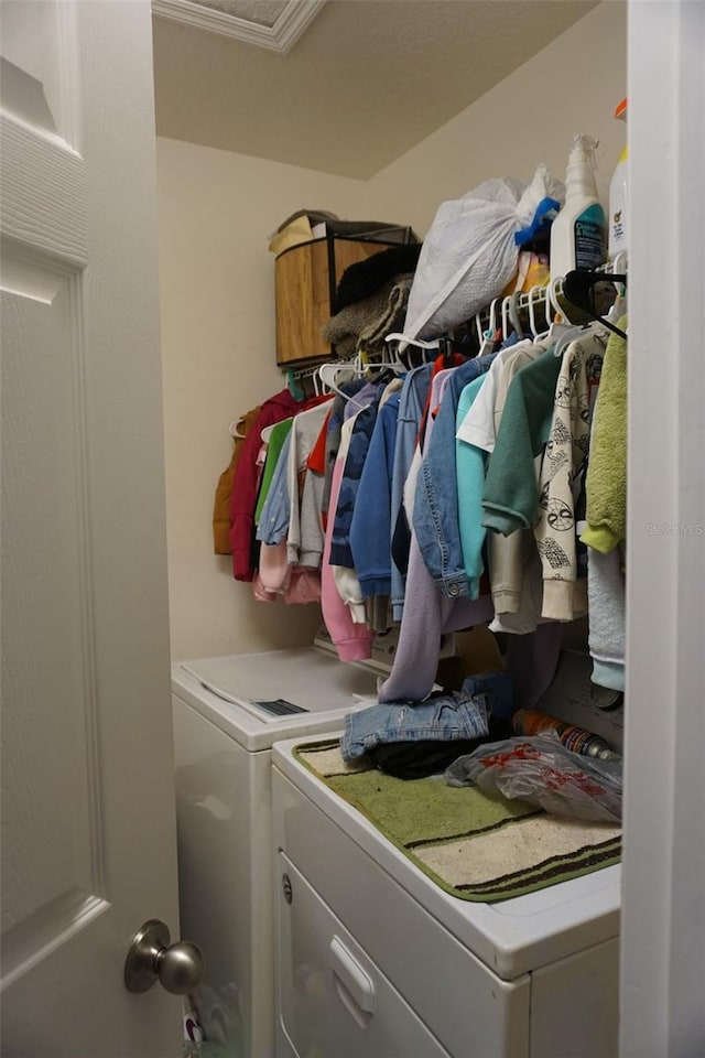 washroom featuring laundry area and washing machine and clothes dryer