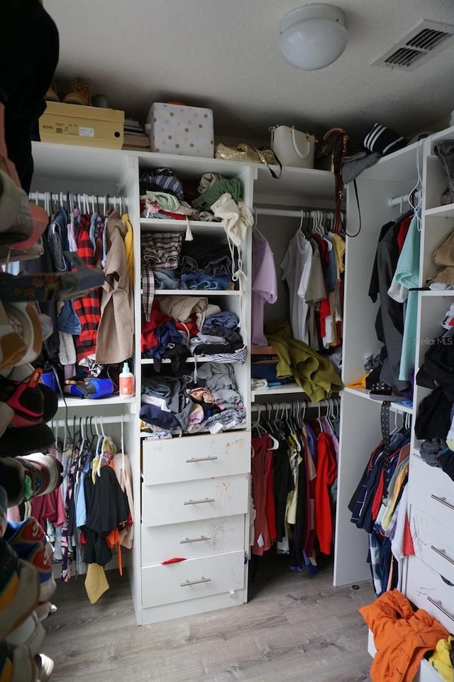 spacious closet with wood finished floors and visible vents