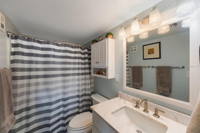 bathroom featuring toilet, a shower with shower curtain, and vanity