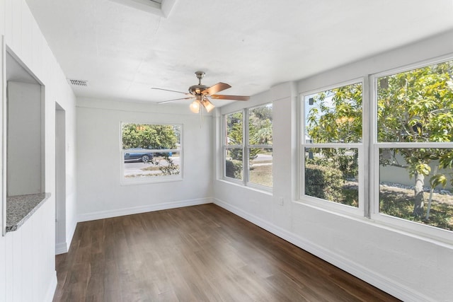 unfurnished sunroom with visible vents and a ceiling fan