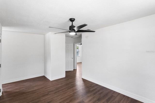 unfurnished room featuring dark wood-style floors, a textured ceiling, a ceiling fan, and baseboards