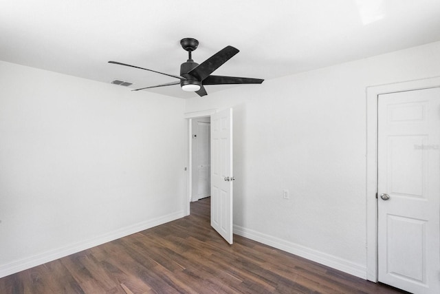 unfurnished bedroom featuring dark wood-type flooring, a ceiling fan, visible vents, and baseboards