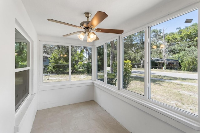 unfurnished sunroom with a ceiling fan