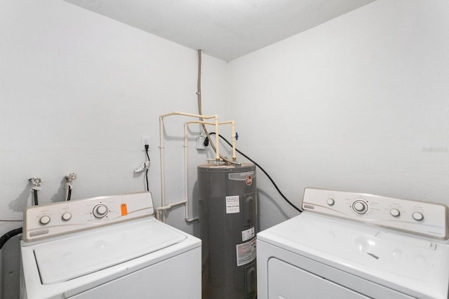 laundry room with water heater, laundry area, and washing machine and dryer