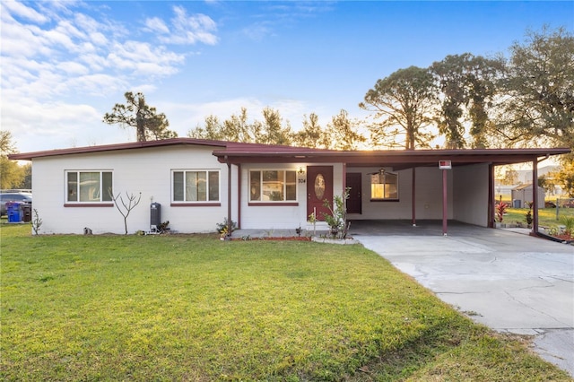 single story home with a carport, a front yard, and driveway